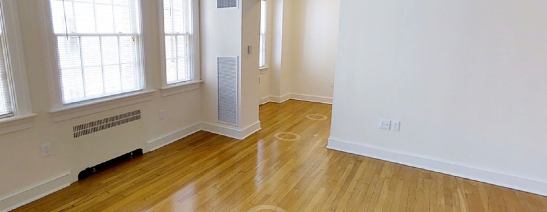 room with hardwood floors and white walls